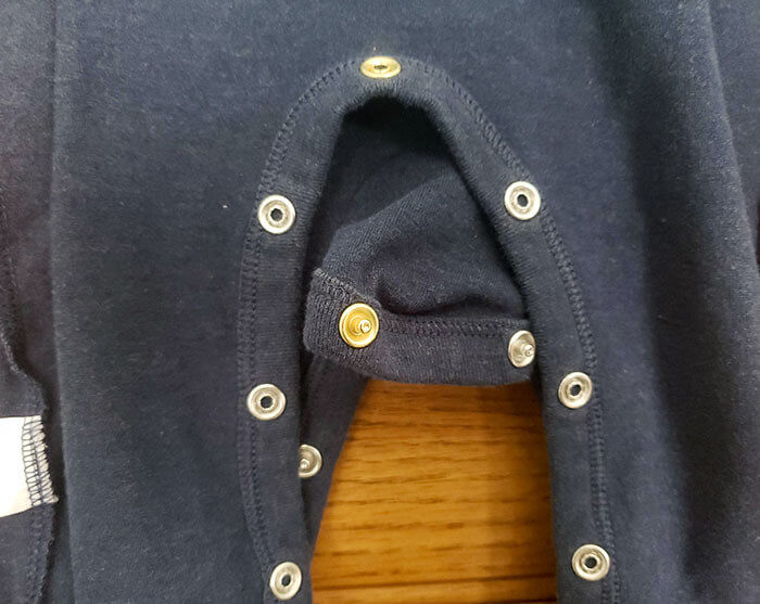 Baby Onesie With a Different Colored Snap Helps Parents Align the Buttons